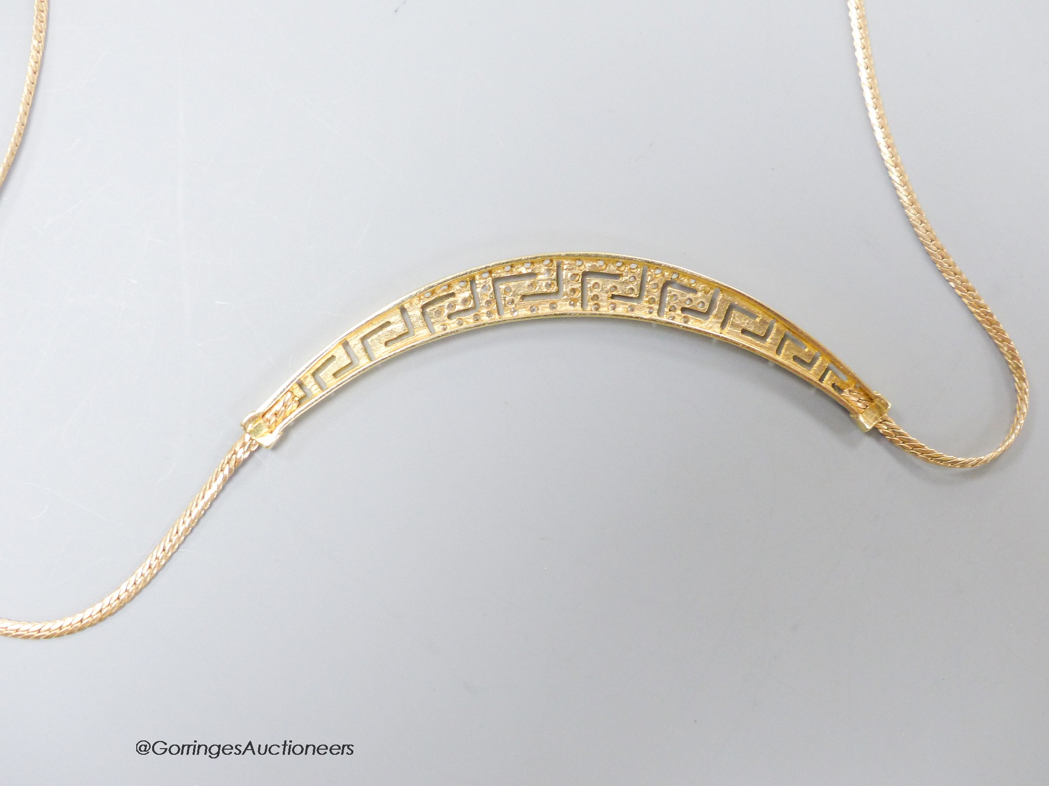 A modern 585 yellow metal and white stone set 'Greek key' pattern necklace, approx. 40cm, gross 8.2 grams.